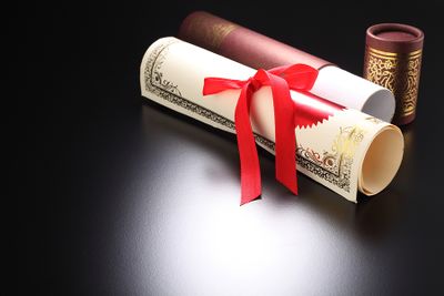 Bigstock-roll-certificate-on-the-black--154840733.jpg