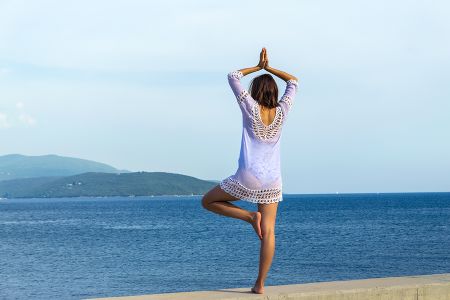Bigstock-Girl-Doing-Yoga-On-Tropical-Be-341339086.jpg
